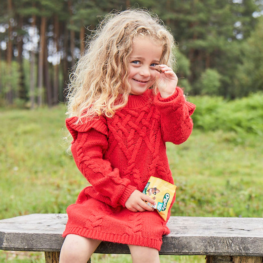 Girl on bench, eating Choco Mini Bites