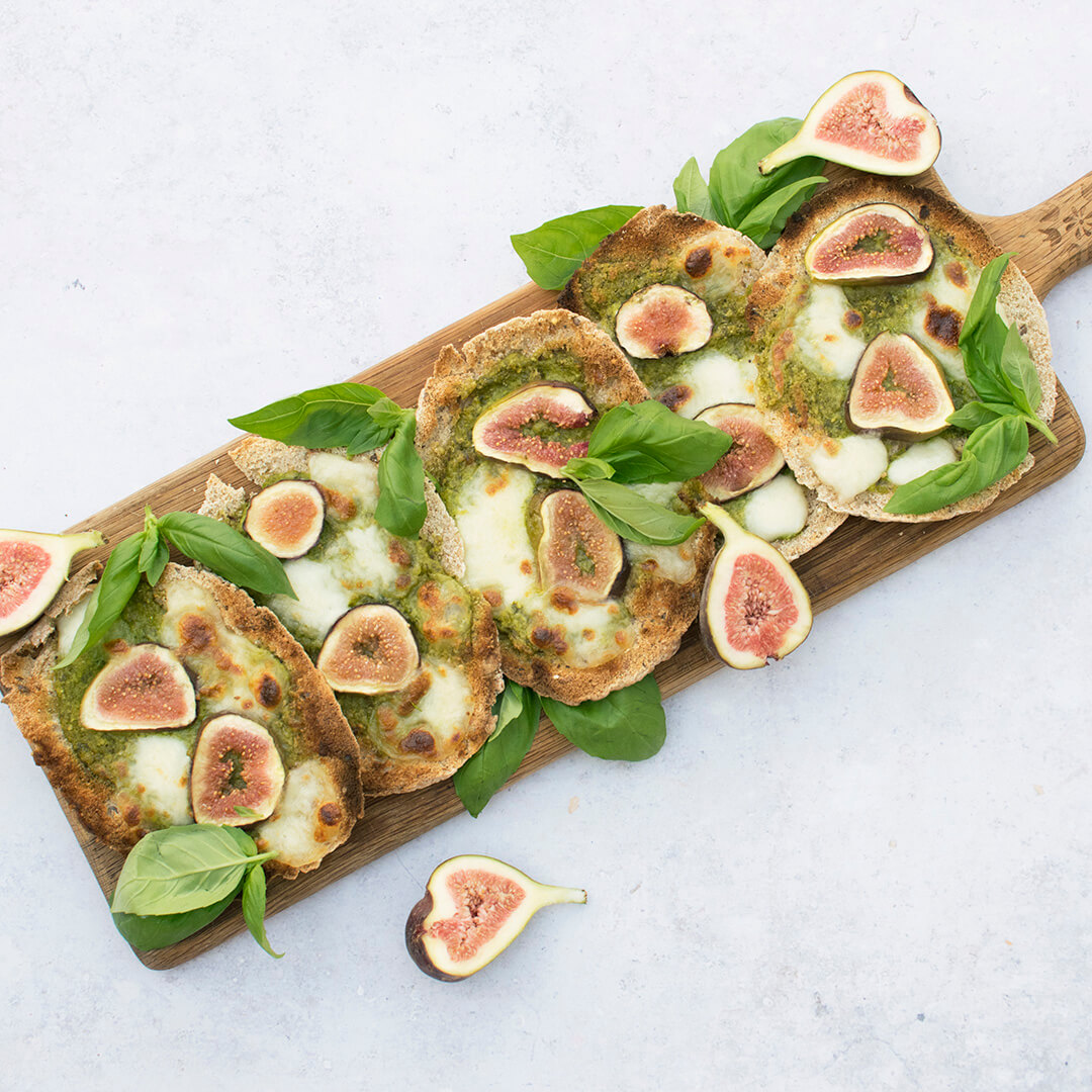 A platter of fig and mozzarella pittas served with halved figs