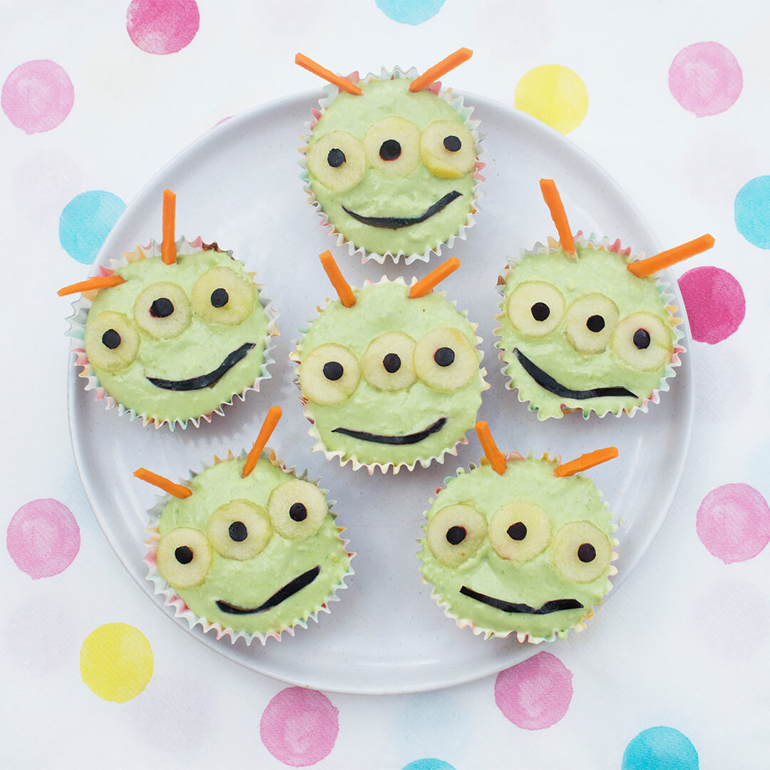 A plate of 6 cupcakes decorated to look like aliens