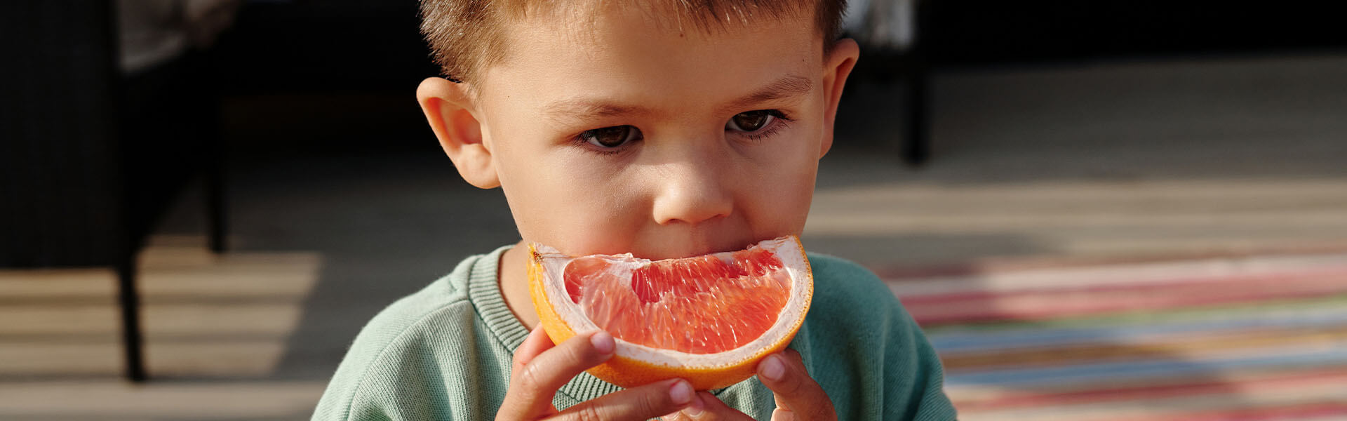 A toddler eating some fruit