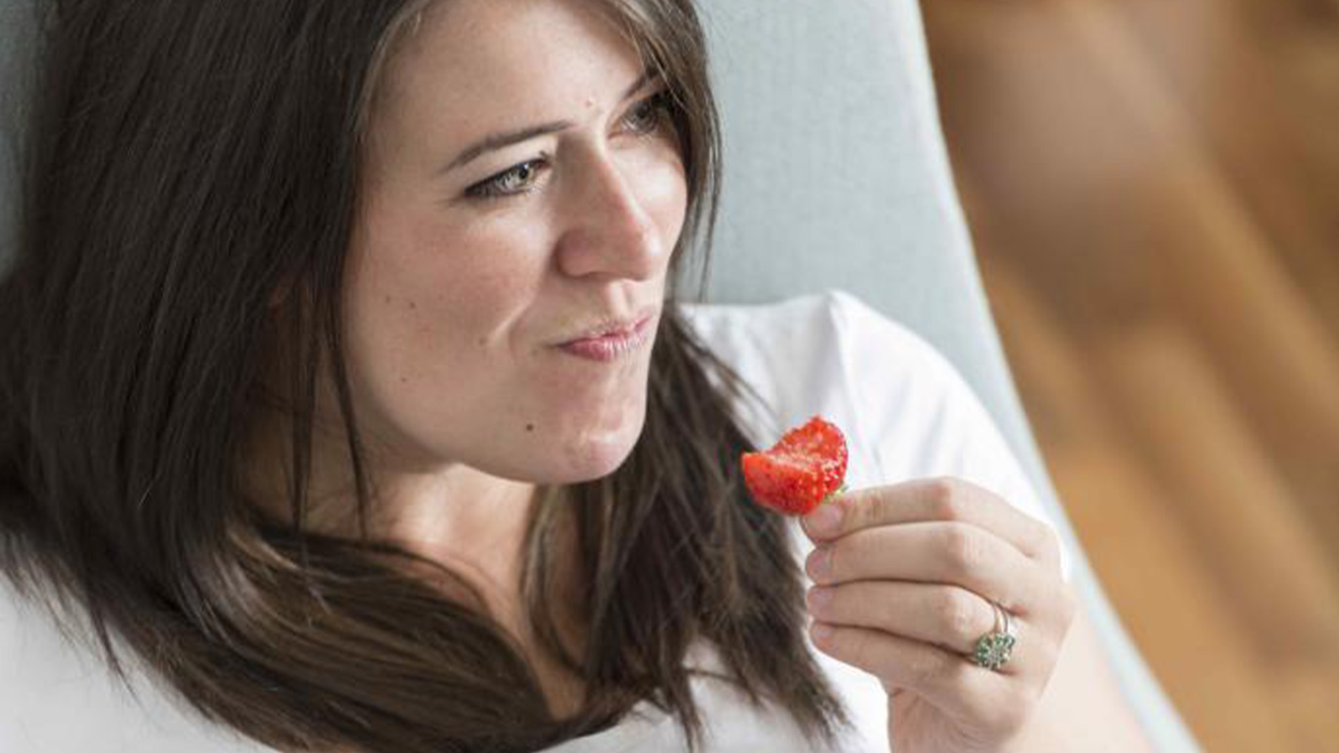 Woman eating a strawberry