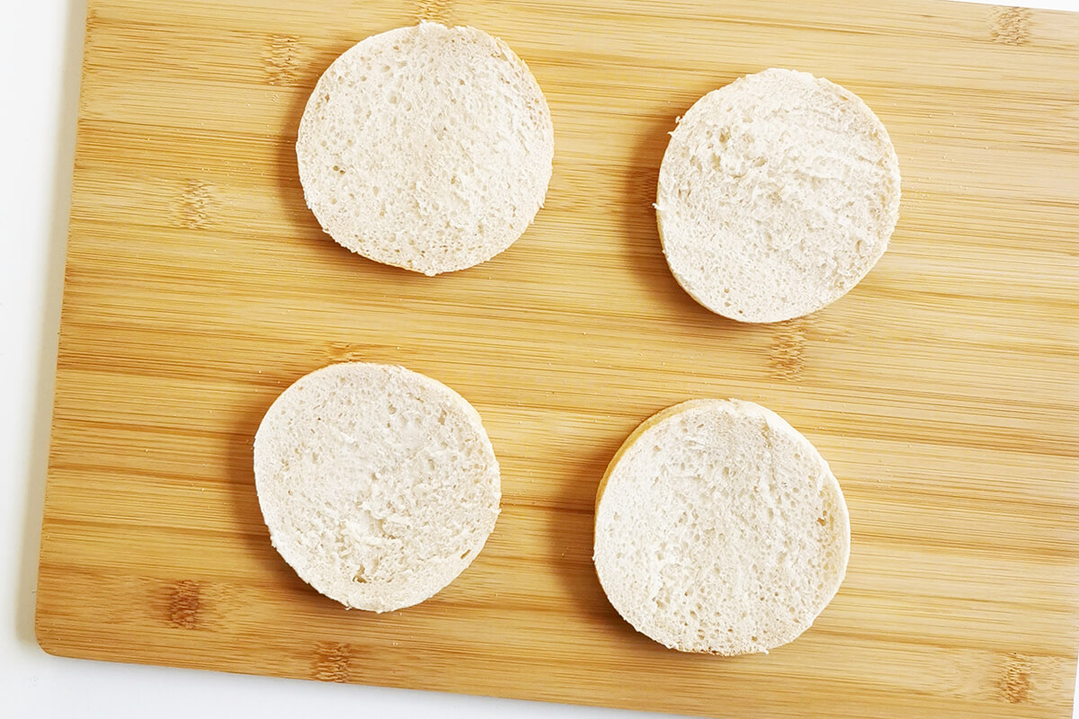 2 halved muffins on a chopping board