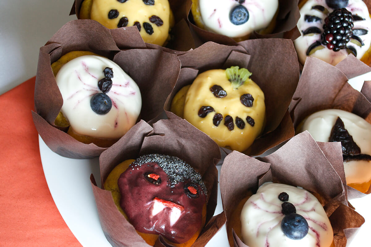 Sweet Halloween Pumpkin Muffins designed to look like pumpkins, spiders, a witches hat and Dracula