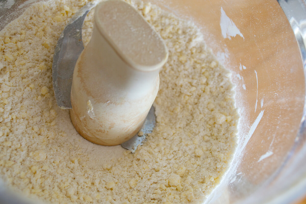 A food processor with flour and butter