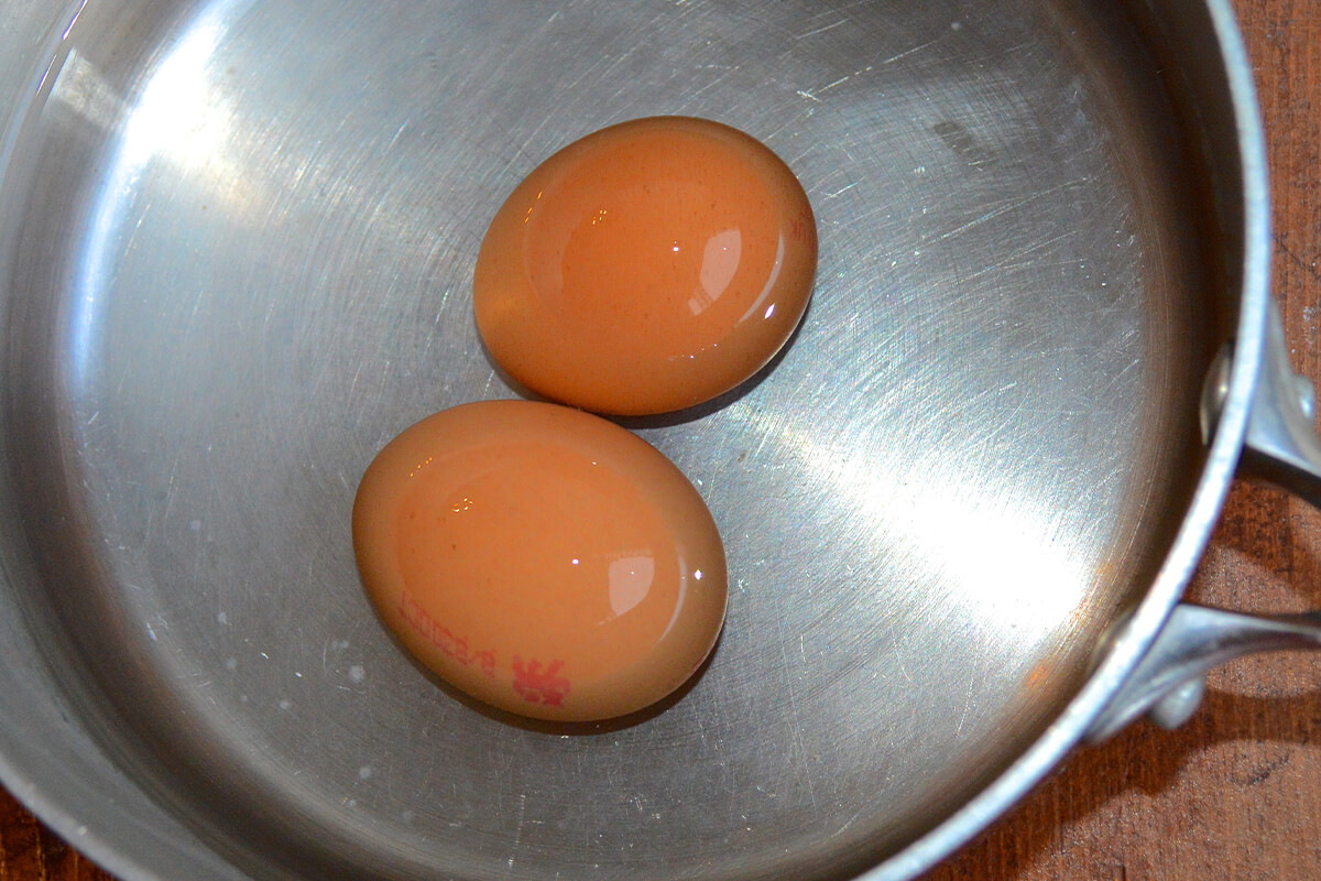 2 eggs in a saucepan of water