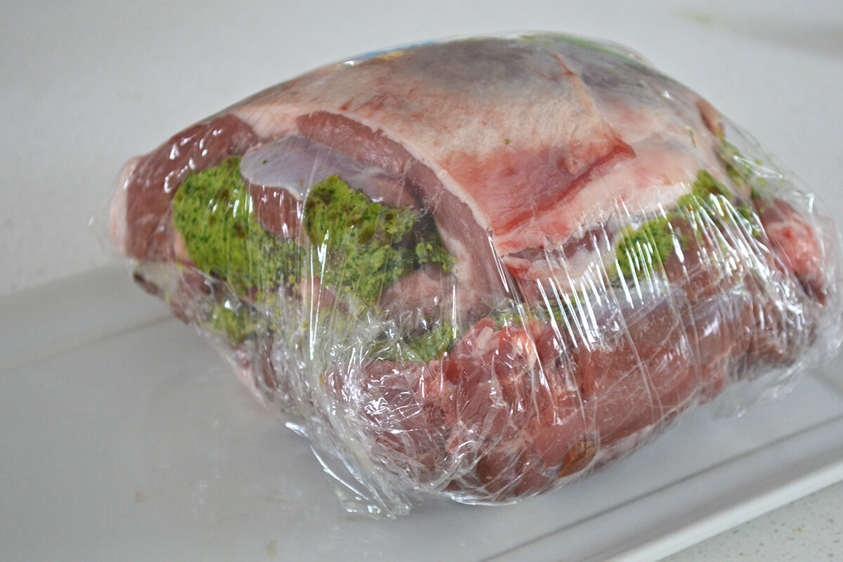 Lamb with apricot and herb paste, rolled in cling film