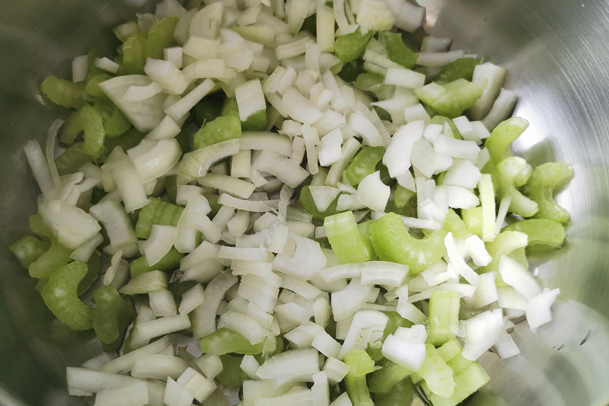 A saucepan with onion and celery