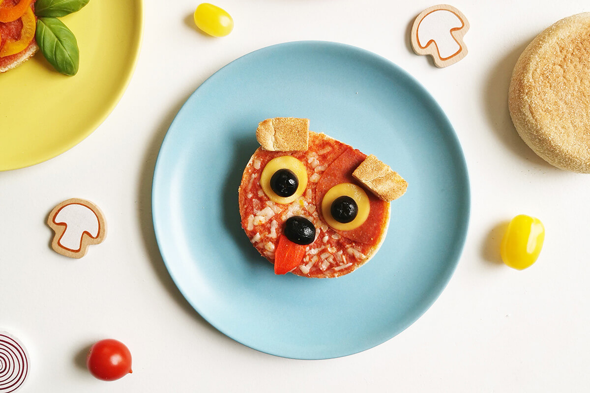 An English muffin pizza designed to look like a dog