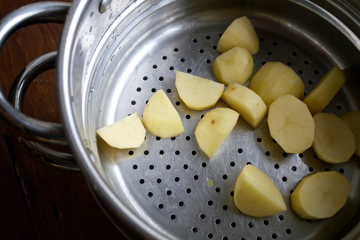 Potatoes being drained in colander 