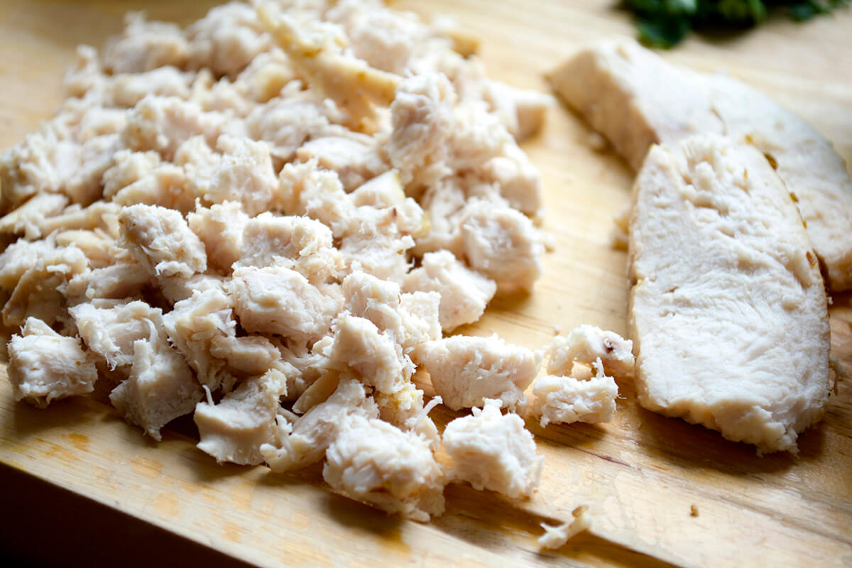 Chopped, cooked chicken on a chopping board