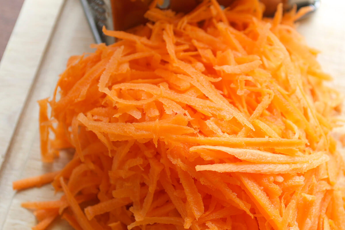 Grated carrot on a chopping board