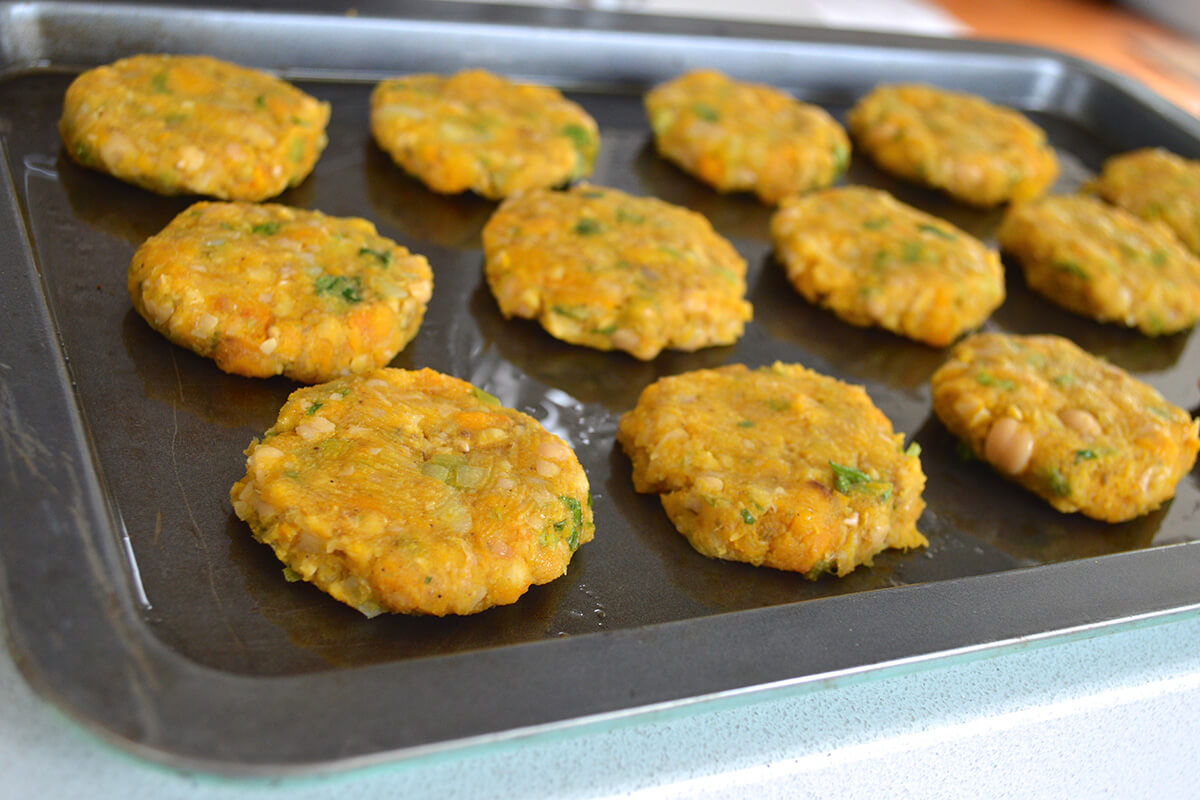 Uncooked chickpea patties on a baking tray