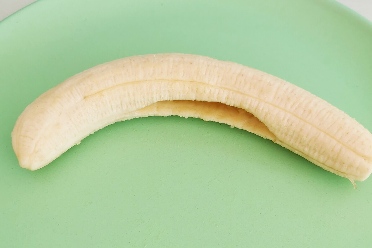 Peeled banana sliced through the middle