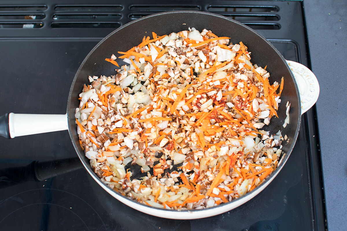 A large pan with chopped onion, mushroom and onions 