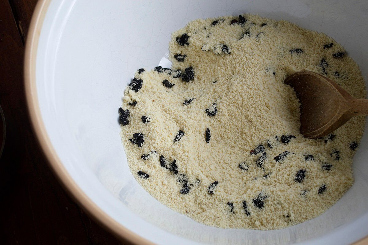 A large bowl of ground almonds and sour cherries