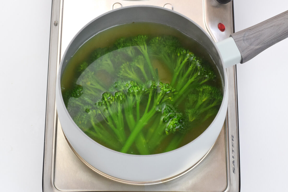 A saucepan of tenderstem broccoli being cooked