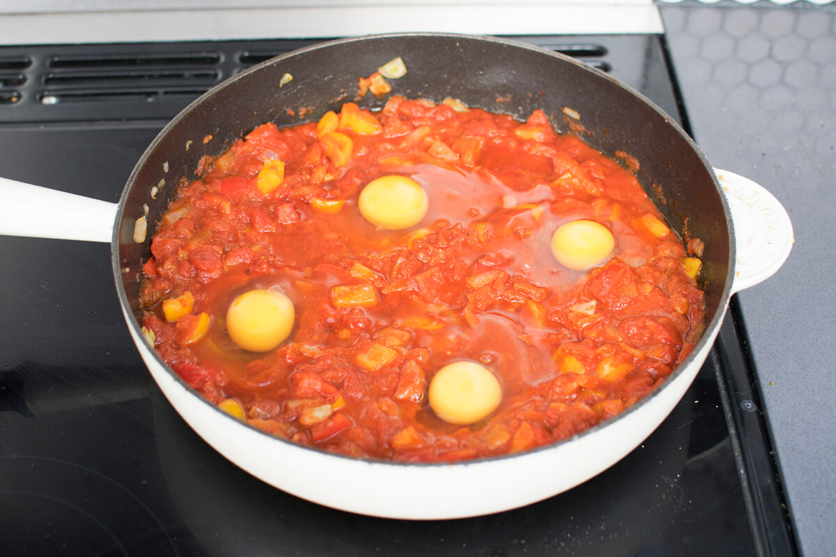 Shakshuka ingredients topped with eggs