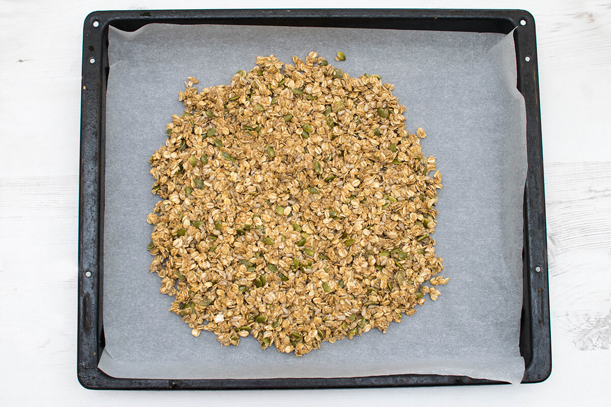 Granola mix on a braking tray lined with baking sheet
