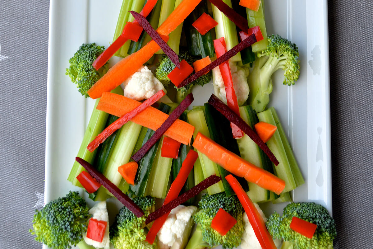Veg Nibbles Christmas Tree made with cauliflower and broccoli florets, celery and cucumber sticks, carrots, red pepper and beetroot