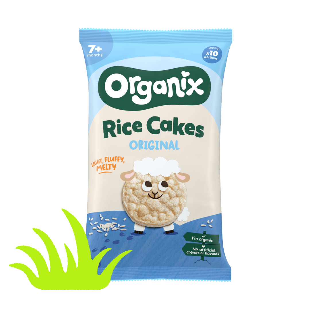A blue pack of Organix Original rice cakes, adorned with a green illustrated patch of grass and a cartoon sheep character made from the rice cake itself